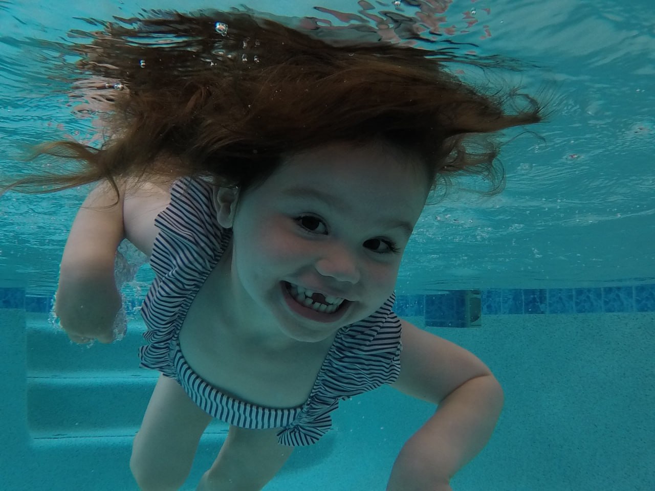 A child swimming underwater during ISR lesson